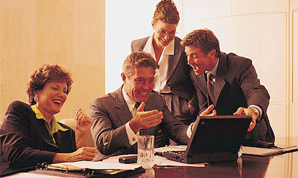 Group of people looking at laptop